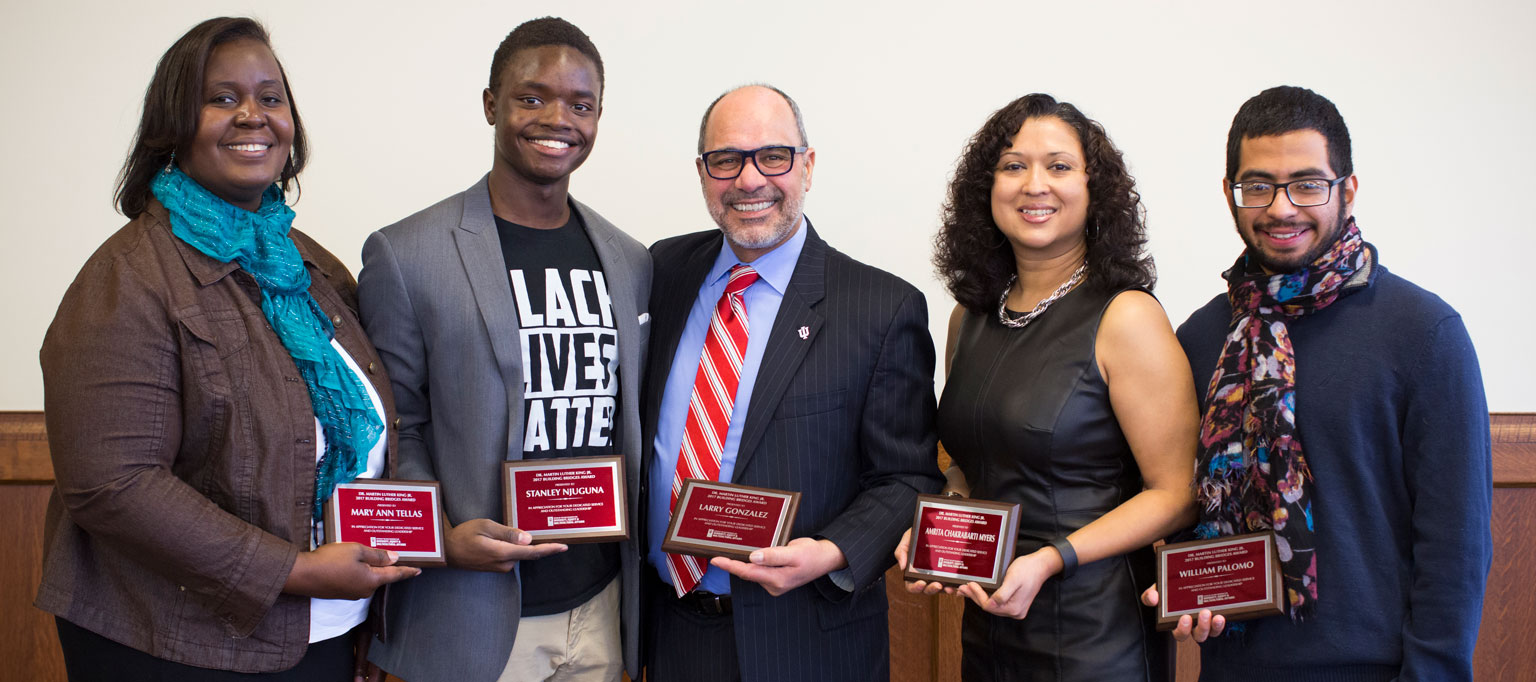 Pictured left to right: Mary Ann Tellas, Larry Gonzalez, Amrita Chakrabarti Myers, Stanley Njuguna, William Palomo--recipients of 2017 Building Bridges award pose with their plaques.